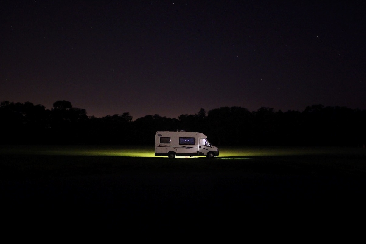 Camper van parked in the middle of nowhere with no surrounding lights