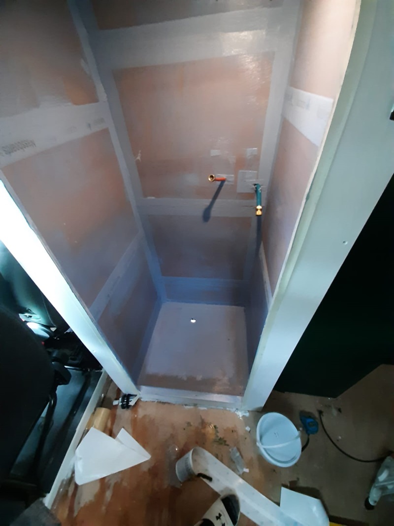 Inside shower cubical being built with plumbing out of shower