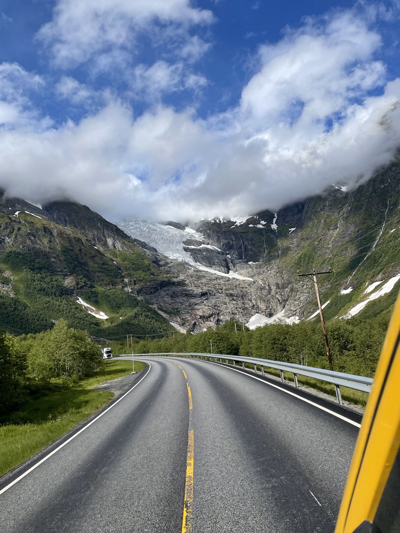 On the road in the swiss alps, photo on the move in van of road ahead with alps in background