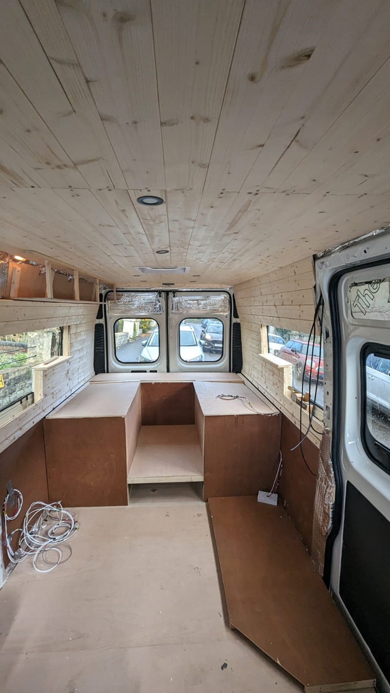Sunny Peugeto boxer van being converted wooden inside fitout on roof walls and kitchen fitout at back of van