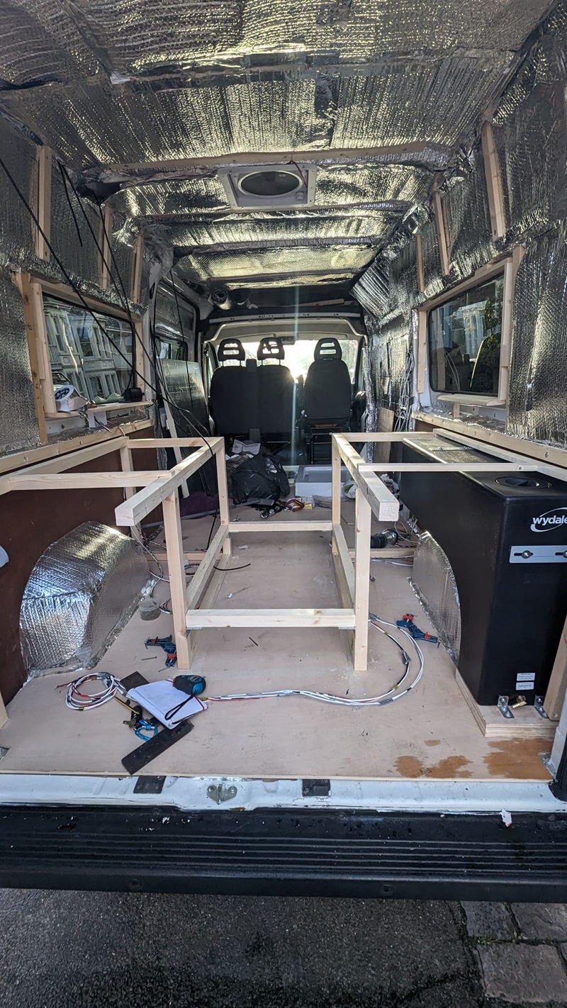 van conversion creating vapour barrier with reflective material on van ceiling and walls