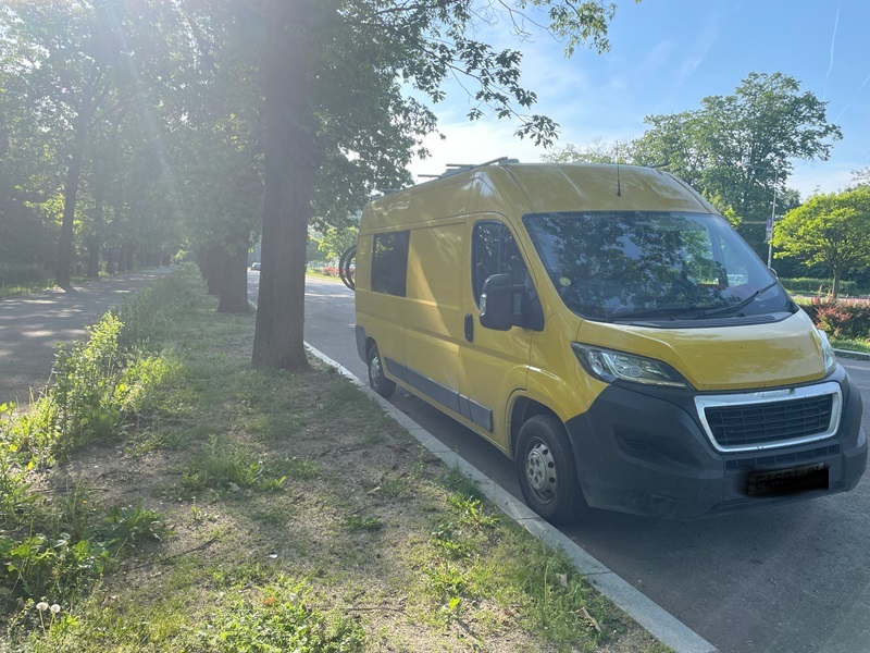 bright yellow Peugeot boxer parked on side of road, Daniela's van